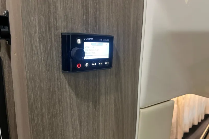 Slide: The Image of Control panel on 2019 Regal 33 Express boat interior, featuring Fusion MS-RA70N stereo system. - 38