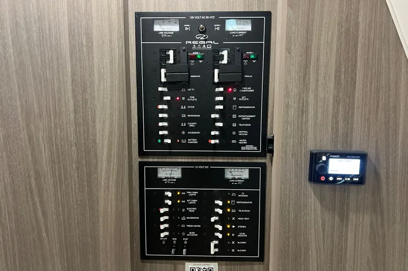 Slide: The Image of Electrical control panel of a 2019 Regal 33 Express boat, featuring switches and indicators. - 39