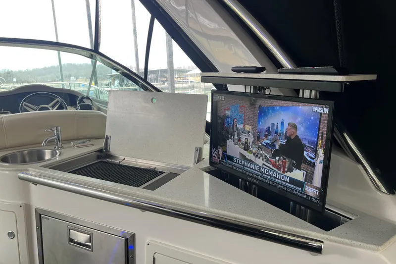 Slide: The Image of Luxurious 2019 Regal 33 Express yacht interior with TV and kitchenette. - 42