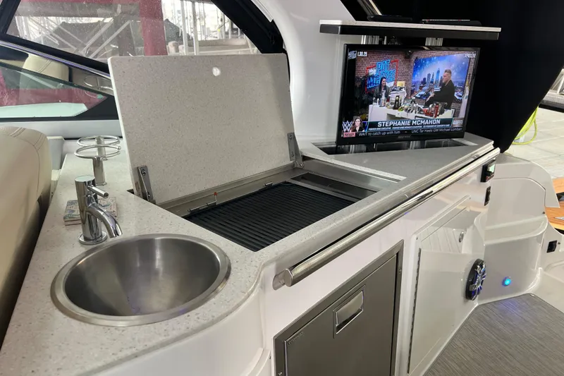 Slide: The Image of 2019 Regal 33 Express yacht interior with kitchenette and TV. - 43