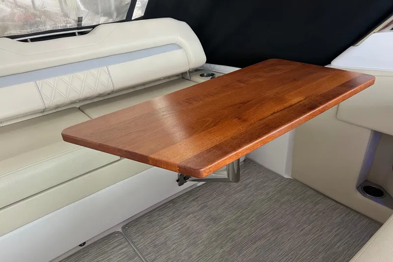 Slide: The Image of Luxurious interior of 2019 Regal 33 Express with elegant wooden table and plush seating. - 47