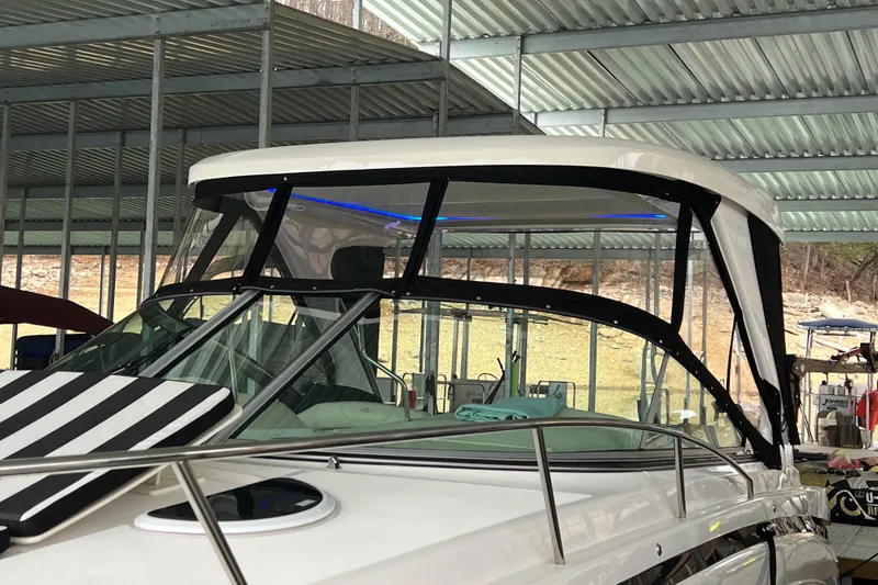 Slide: The Image of 2019 Regal 33 Express boat docked under a metal canopy. - 6