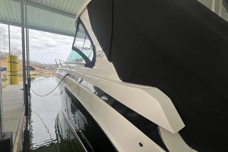 Slide: The Image of 2019 Regal 33 Express boat docked under a covered marina. - 9