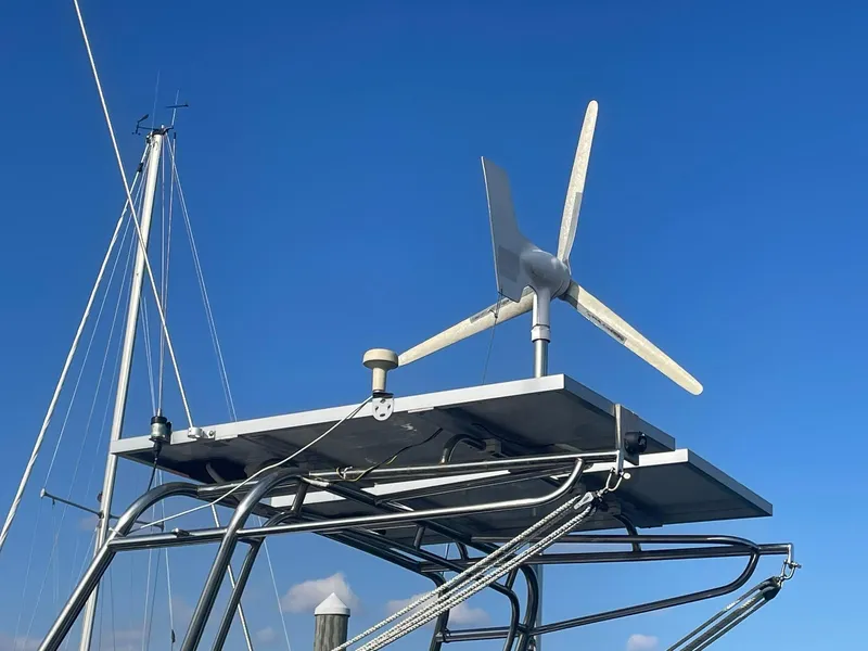 Slide: The Image of Wind turbine on a 1987 Passport 51 sailboat against a clear blue sky. - 11