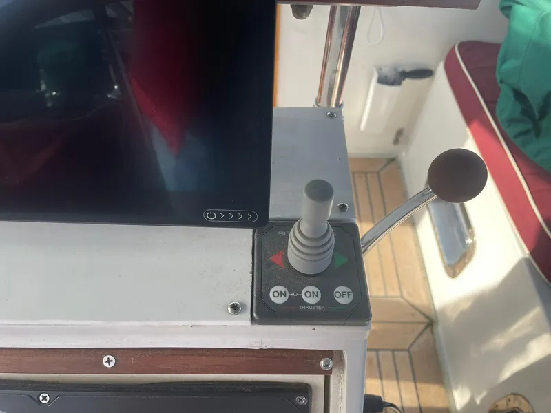 Slide: The Image of Control panel with joystick and buttons on a 1987 Passport 51 boat. - 14