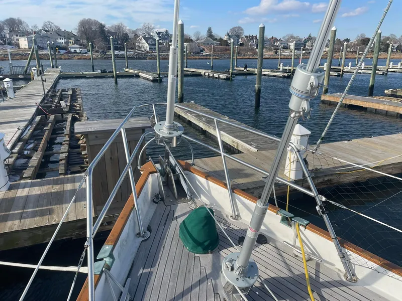 Slide: The Image of Sailboat docked at marina, Passport 51 model, 1987, with clear sky and waterfront view. - 16