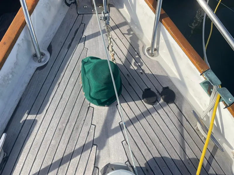 Slide: The Image of Deck of 1987 Passport 51 sailboat with green cover and ropes. - 17