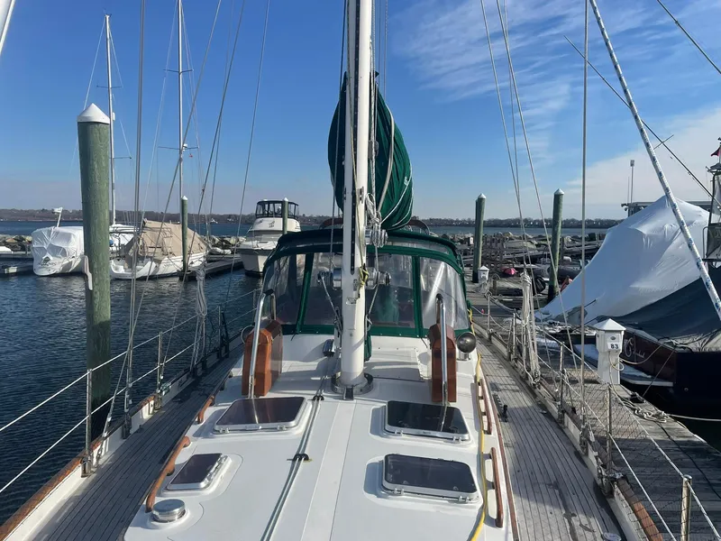 Slide: The Image of Sailboat docked at marina, Passport 51 model, 1987, with clear sky and calm water. - 18