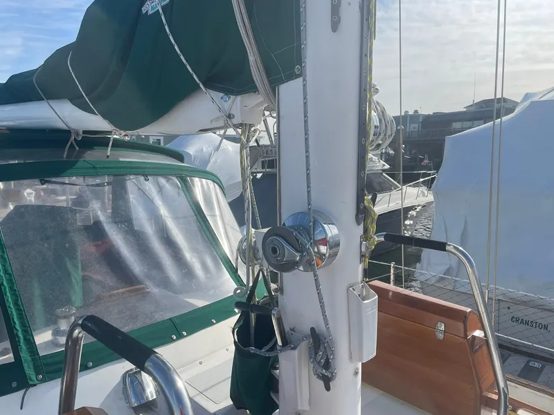 Slide: The Image of Sailboat deck with green canopy, winch, and wooden seating, Passport 51 model, 1987. - 19