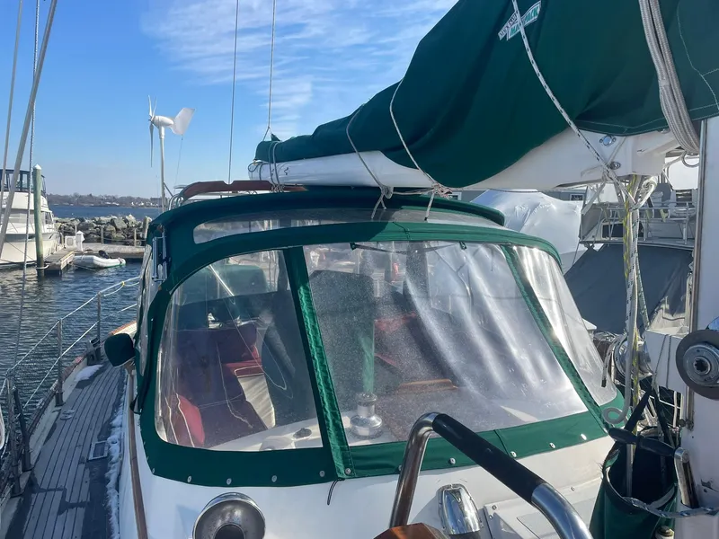 Slide: The Image of Sailboat docked at marina, green canopy, Passport 51 model, 1987. - 22