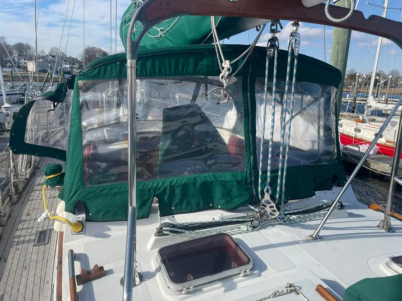 Slide: The Image of Sailboat deck with green canopy, Passport 51 model, 1987, docked at marina. - 23