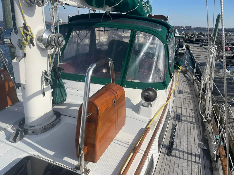 Slide: The Image of 1987 Passport 51 sailboat with green canopy docked at marina. - 25