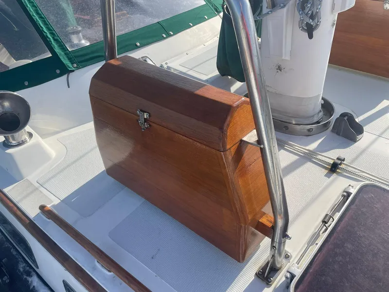 Slide: The Image of Wooden helm seat on 1987 Passport 51 sailboat deck, featuring stainless steel railings. - 26