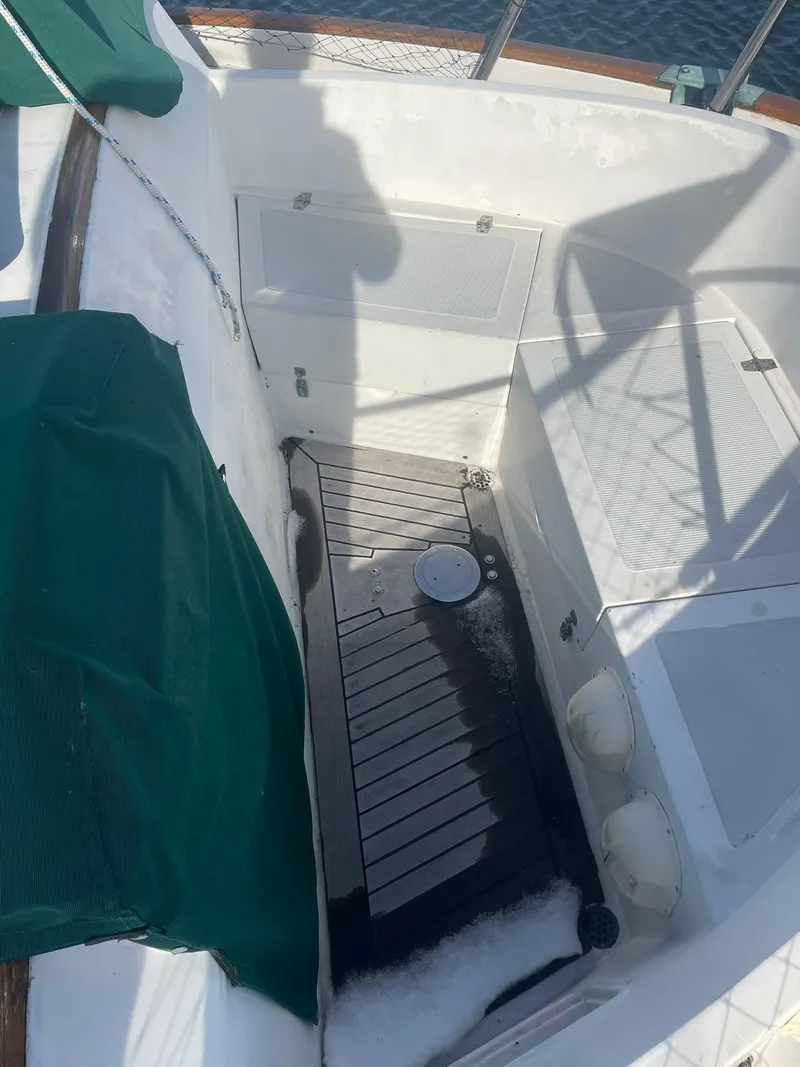 Slide: The Image of Cockpit of 1987 Passport 51 sailboat with green covers and wooden flooring. - 27