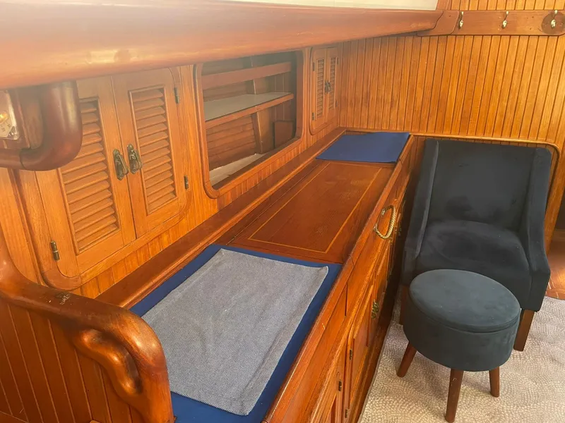 Slide: The Image of Wooden interior of 1987 Passport 51 yacht with blue chair and ottoman. - 37