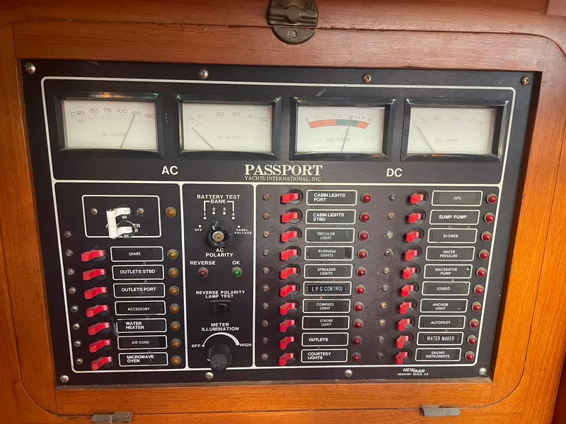 Slide: The Image of Control panel of a 1987 Passport 51 yacht with AC and DC meters. - 38