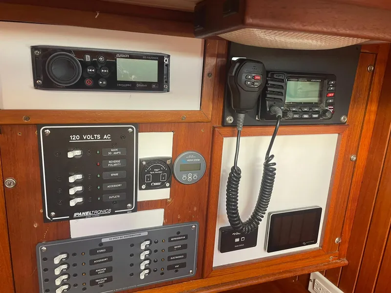 Slide: The Image of Control panel with radio and electrical switches on a 1987 Passport 51 boat. - 39