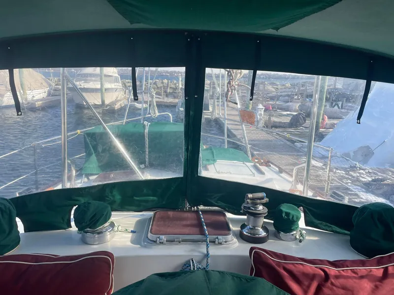 Slide: The Image of Interior view of a 1987 Passport 51 yacht cockpit with marina in the background. - 4