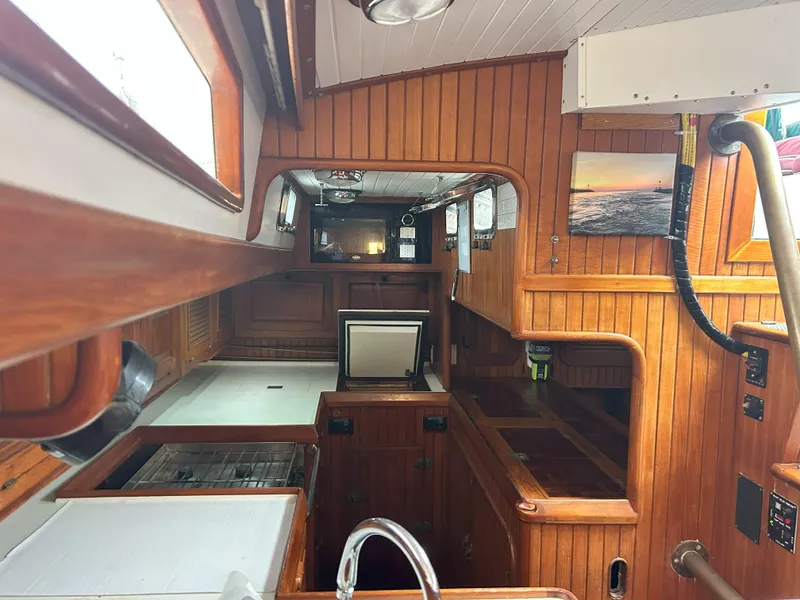 Slide: The Image of Interior of 1987 Passport 51 sailboat with wooden cabinetry and nautical decor. - 48