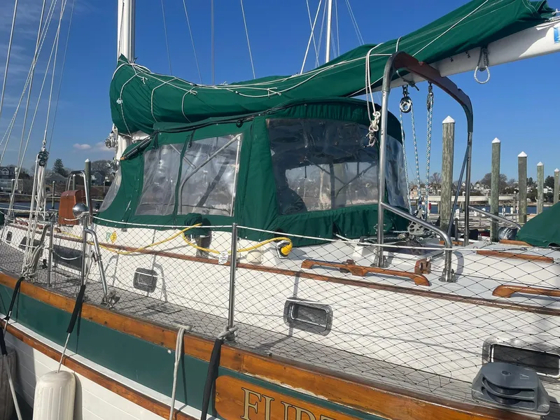 Slide: The Image of Sailboat docked with green canopy, Passport 51 model, 1987. - 5