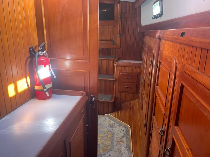 Slide: The Image of Interior of 1987 Passport 51 yacht with wooden cabinetry and fire extinguisher. - 57