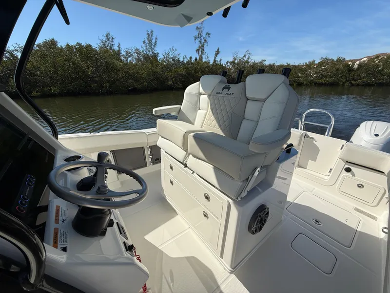 Slide: The Image of 2025 World Cat 280 CC-X boat interior with dual seats and steering wheel. - 10
