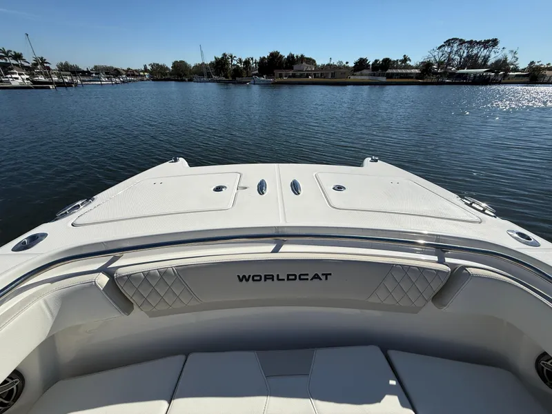 Slide: The Image of 2025 World Cat 280 CC-X boat on calm water, showcasing spacious deck and seating. - 16