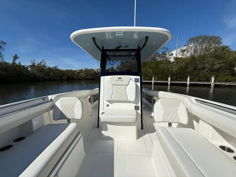 Slide: The Image of 2025 World Cat 280 CC-X boat interior with white seating and sleek design. - 17