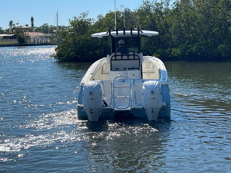 Slide: The Image of 2025 World Cat 280 CC-X boat cruising on a sunny waterway. - 4