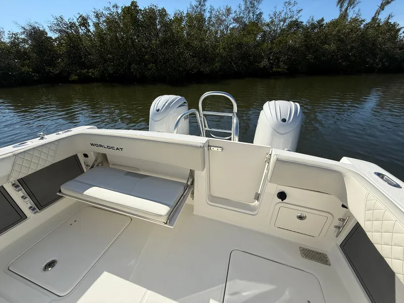 Slide: The Image of 2025 World Cat 280 CC-X boat interior with seating and twin engines on a calm waterway. - 7