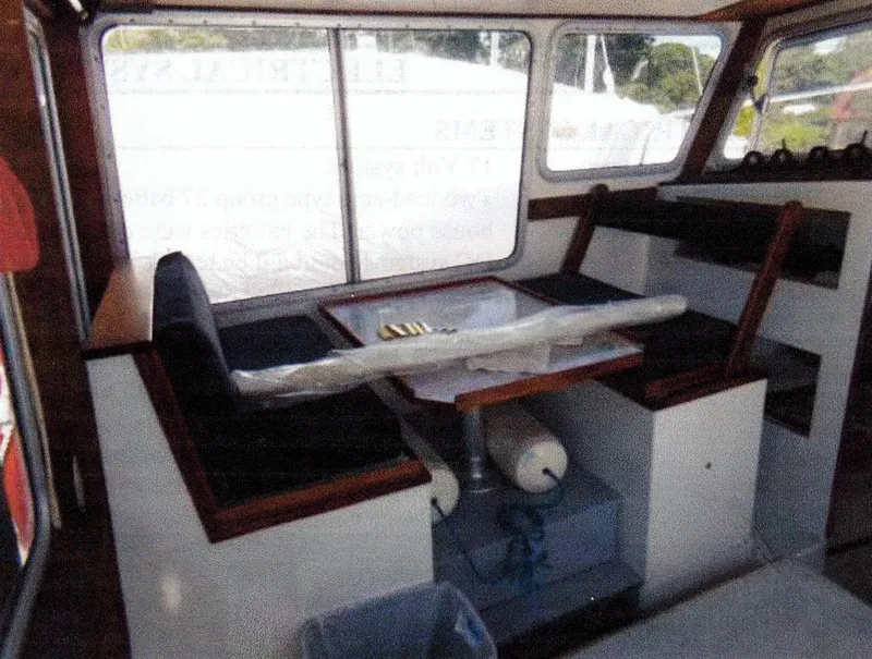 Slide: The Image of Interior of 1999 Custom 30 Novi Hardtop Cruiser with seating and table. - 1