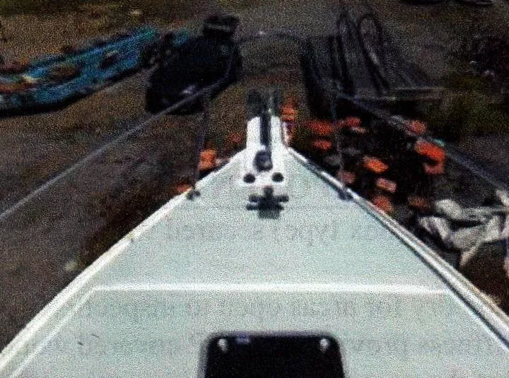 Slide: The Image of Bow view of a 1999 Custom 30 Novi Hardtop Cruiser on land. - 10