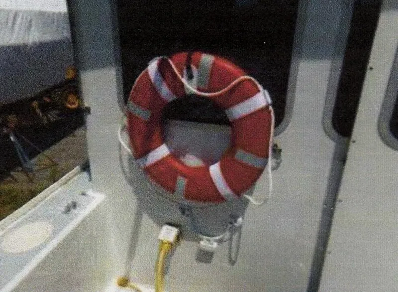 Slide: The Image of Red life ring on 1999 Custom 30 Novi Hardtop Cruiser deck. - 13