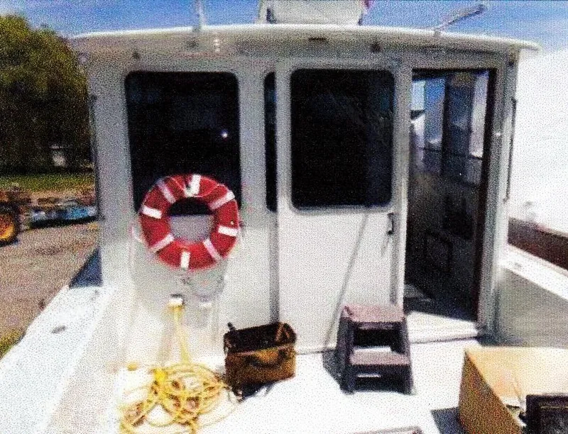 Slide: The Image of 1999 Custom 30 Novi Hardtop Cruiser with life preserver and equipment on deck. - 14