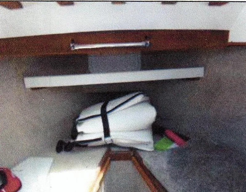 Slide: The Image of Interior of 1999 Custom 30 Novi Hardtop Cruiser with folded white cushions and wooden accents. - 4