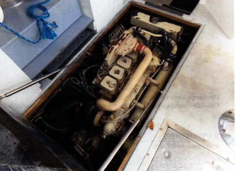 Slide: The Image of Engine compartment of a 1999 Custom 30 Novi Hardtop Cruiser, showcasing mechanical components. - 8