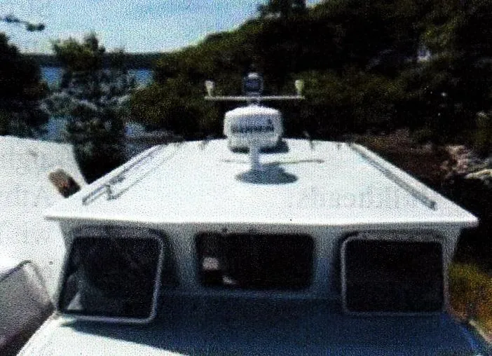 Slide: The Image of Custom 1999 30 Novi Hardtop Cruiser with radar, docked near trees and water. - 9