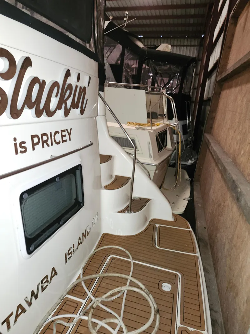 Slide: The Image of 1996 Sea Ray 420 Aft Cabin yacht docked in a storage facility. - 14