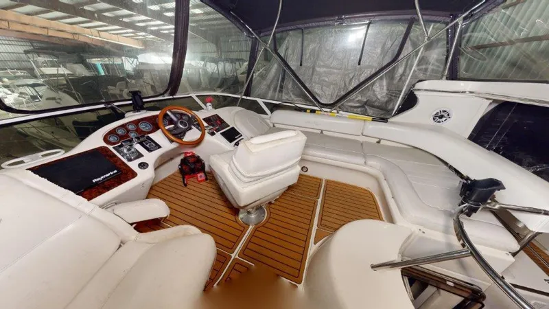 Slide: The Image of 1996 Sea Ray 420 Aft Cabin yacht interior with helm and seating area. - 2