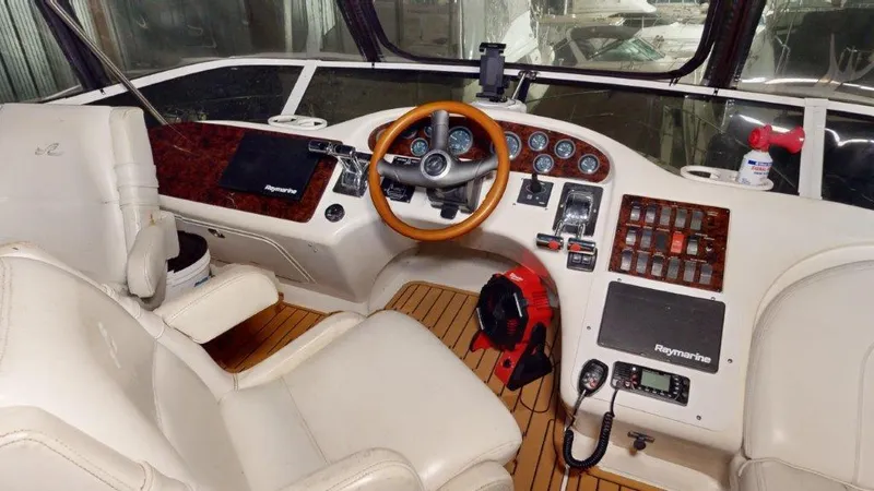 Slide: The Image of 1996 Sea Ray 420 Aft Cabin helm with wood accents and modern navigation equipment. - 20