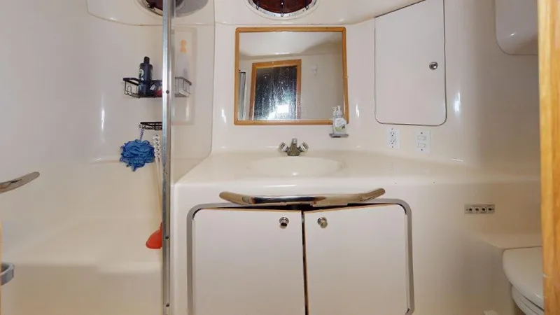 Slide: The Image of Bathroom interior of 1996 Sea Ray 420 Aft Cabin yacht, featuring sink and storage. - 7