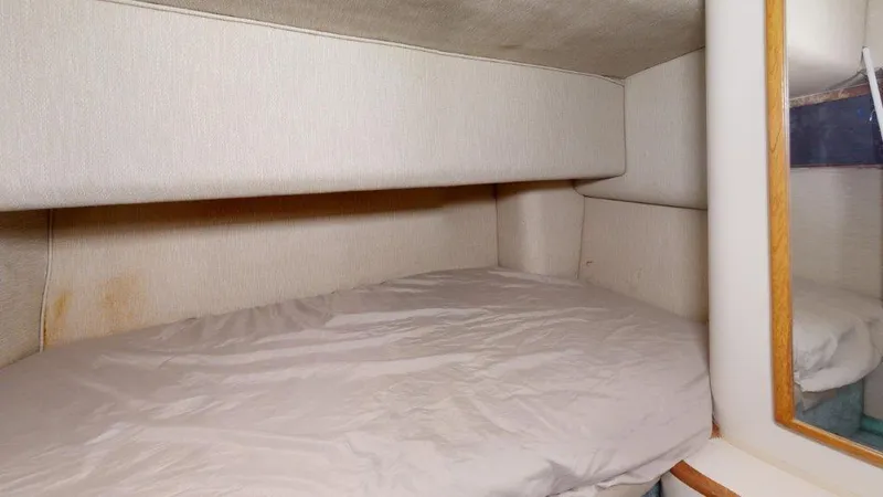 Slide: The Image of 1996 Sea Ray 420 Aft Cabin interior with cozy sleeping area and mirror. - 9