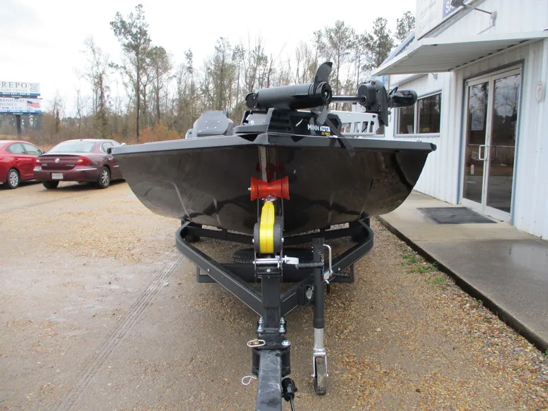 Slide: The Image of 2025 Avid 18 Vertex boat on trailer, parked outside dealership. - 2
