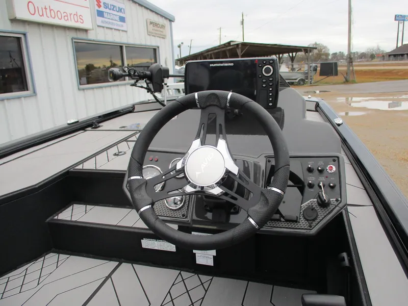 Slide: The Image of 2025 Avid 18 Vertex boat dashboard with steering wheel and control panel. - 7