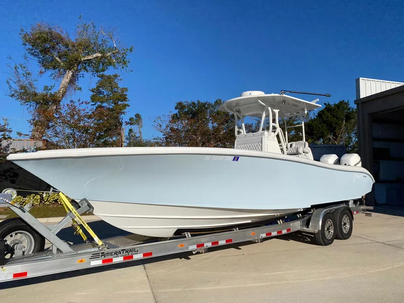 Slide: The Image of 2019 Yellowfin 29 Offshore boat on trailer, parked outdoors. - 1