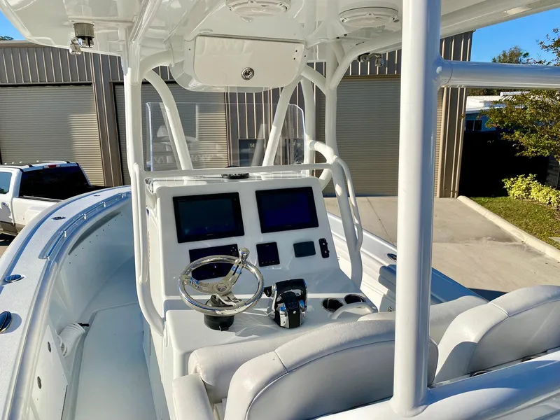 Slide: The Image of 2019 Yellowfin 29 Offshore boat cockpit with dual screens and steering wheel. - 10