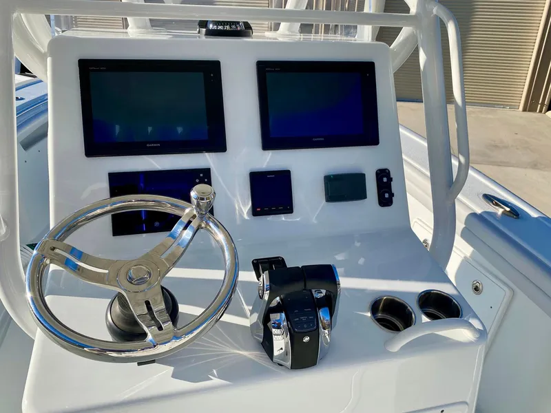 Slide: The Image of 2019 Yellowfin 29 Offshore boat console with dual screens and steering wheel. - 13