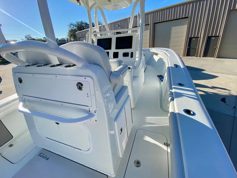 Slide: The Image of 2019 Yellowfin 29 Offshore boat interior with dual helm seats and modern dashboard. - 14