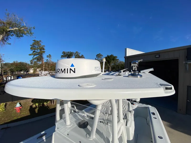 Slide: The Image of 2019 Yellowfin 29 Offshore boat with Garmin radar, docked under clear blue sky. - 16