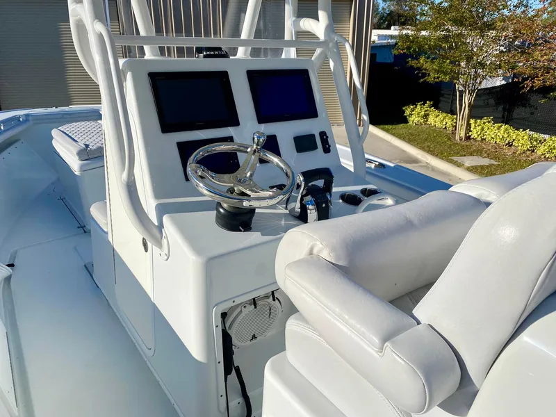 Slide: The Image of 2019 Yellowfin 29 Offshore boat console with dual screens and steering wheel. - 19